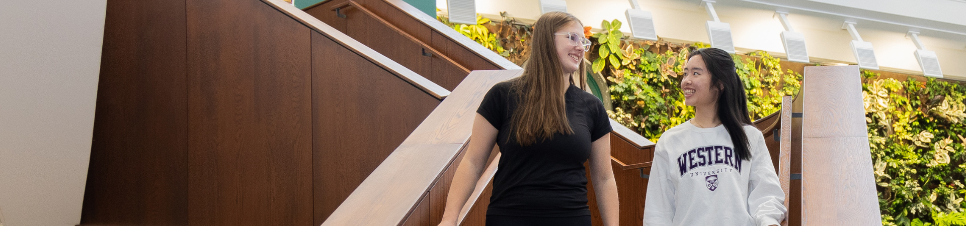 Three scholars students standing, posing for a photo in Thames Hall