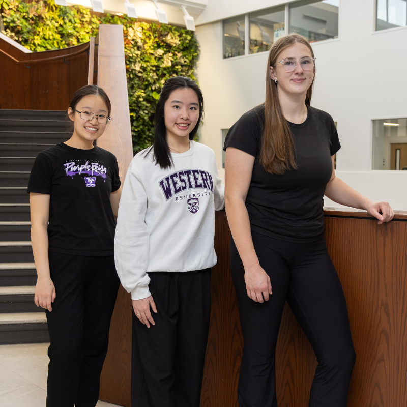 Three scholars students standing, posing for a photo in Thames Hall
